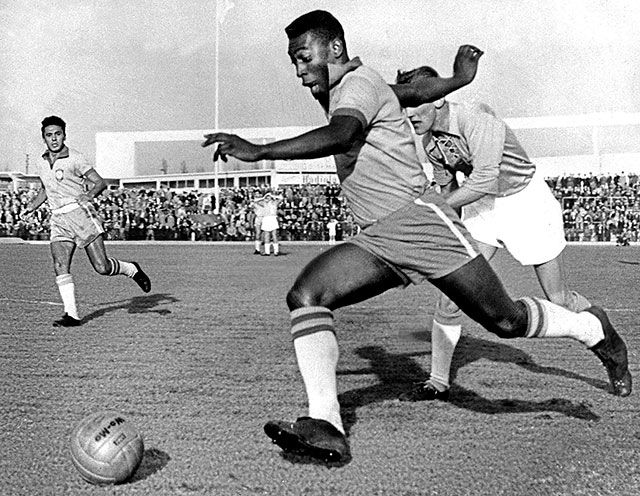 Pele dribbling past a defender